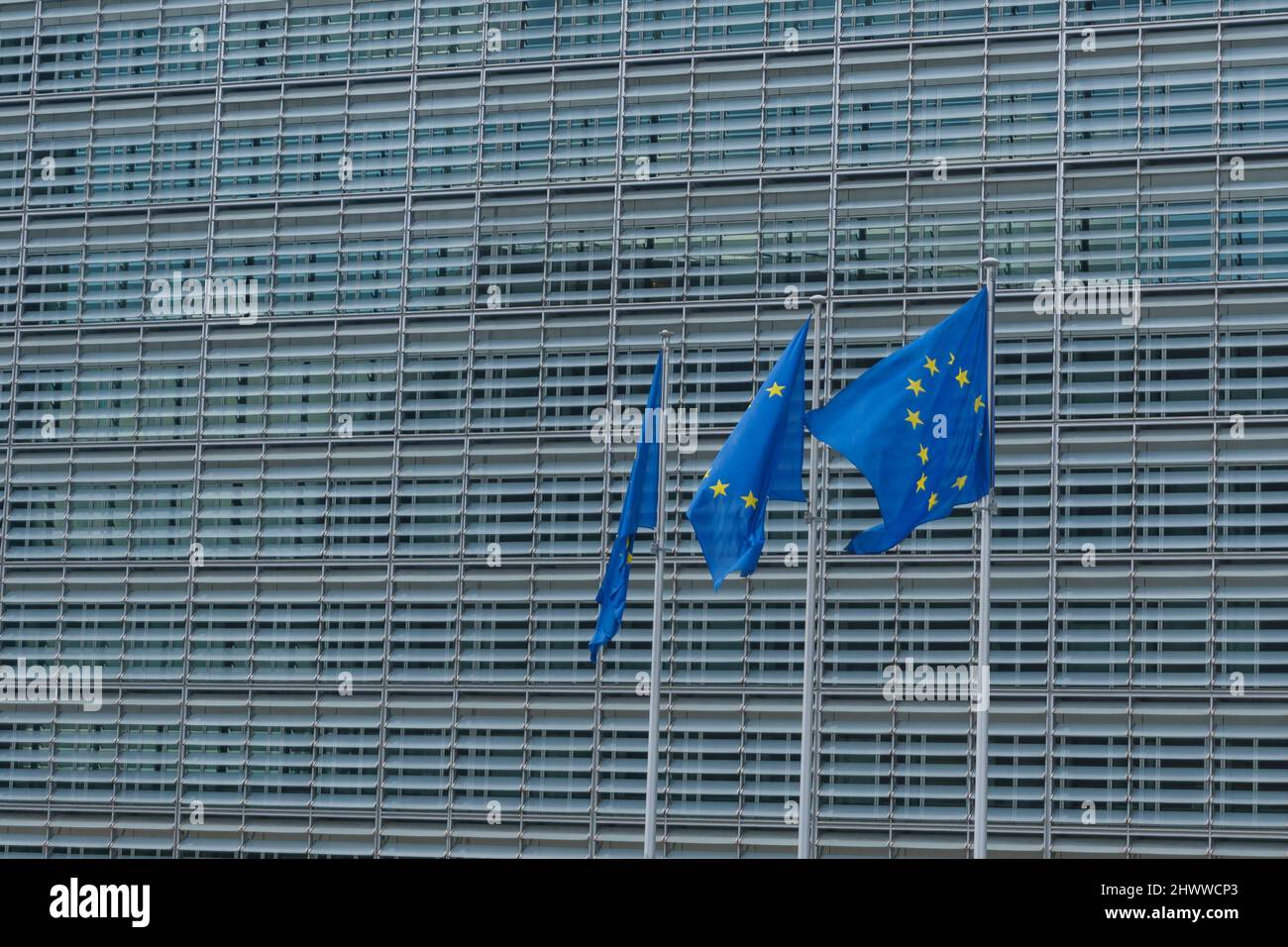 Three EU Flags in front of the European Union Commission building in Brussels, Belgium Stock Photo
