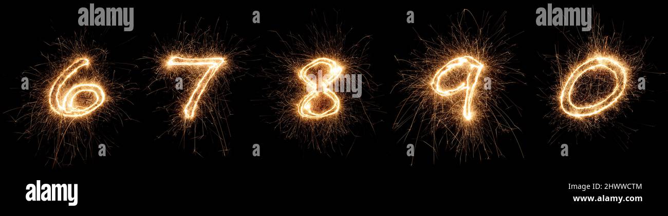 golden bright sparkler number digits font set collection part 6 to 0 isolated on dark black background. silvester new year birthday and celebration de Stock Photo