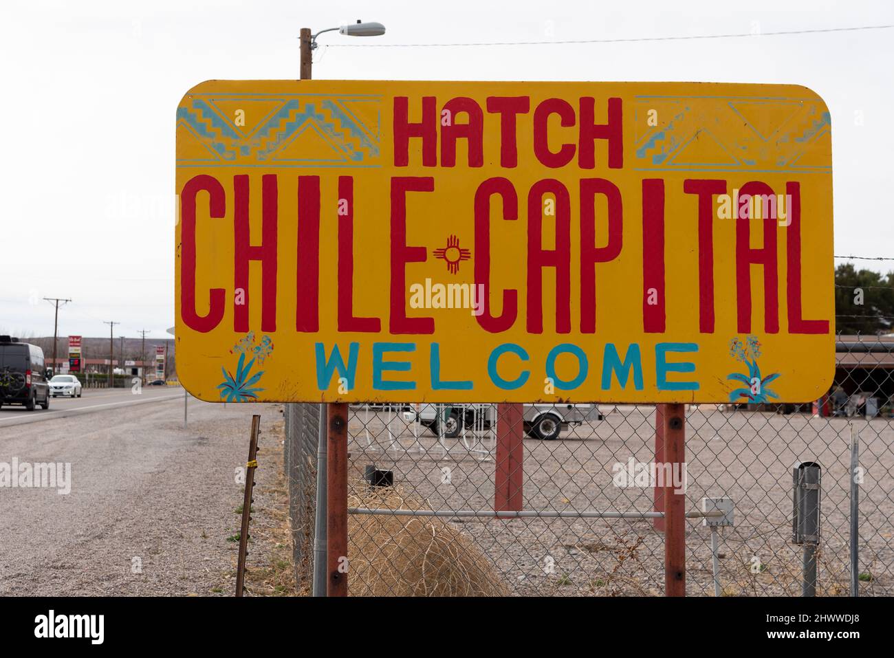 A yellow and red sign alongside the road in Hatch, New Mexico