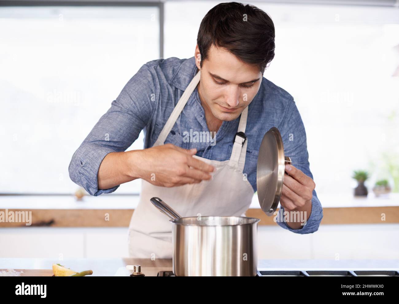 Smell the aroma. Shot of a young man enjoying the aroma of his meal. Stock Photo