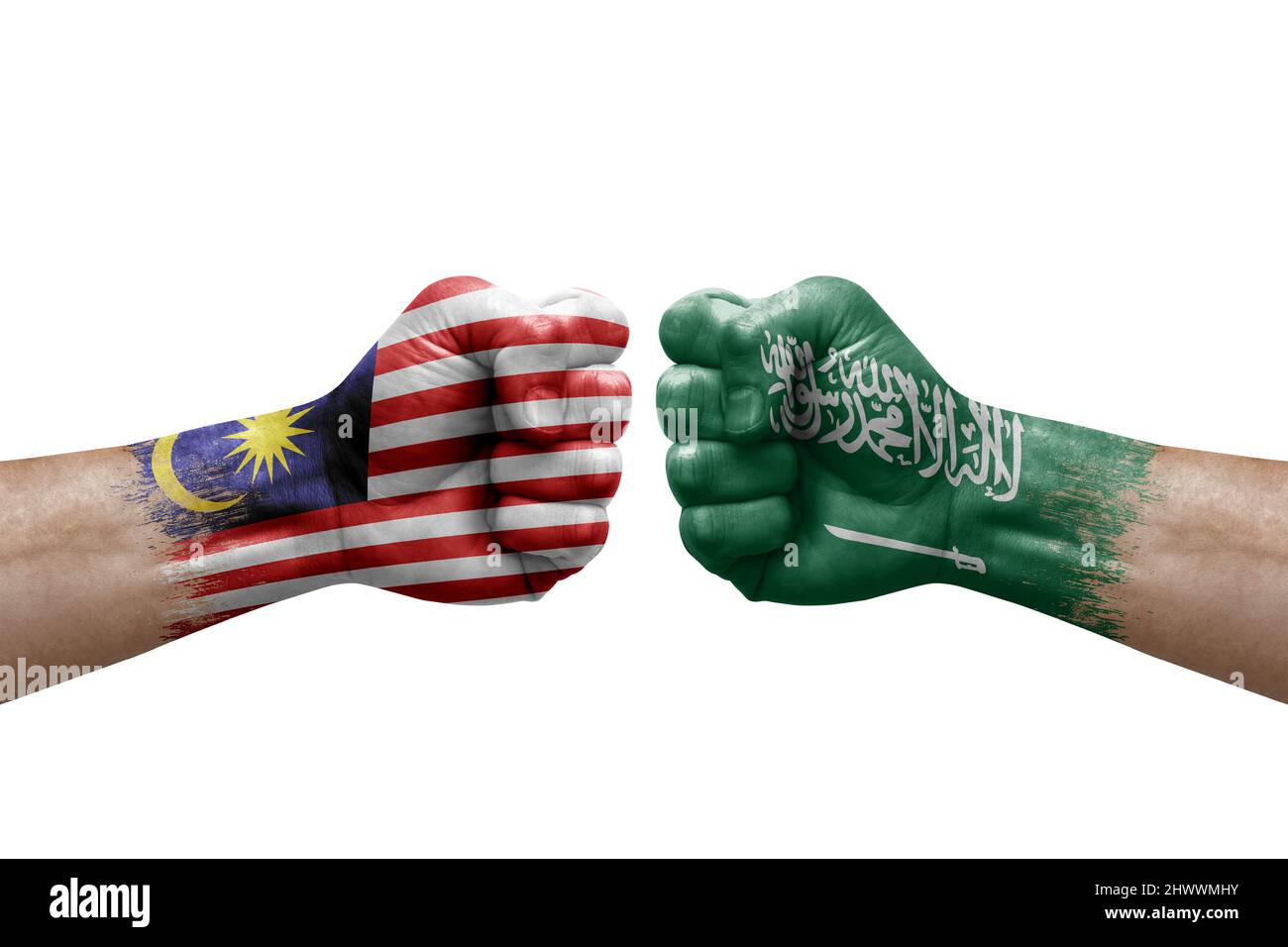Two hands punch to each others on white background. Country flags painted fists, conflict crisis concept between malaysia and saudi arabia Stock Photo