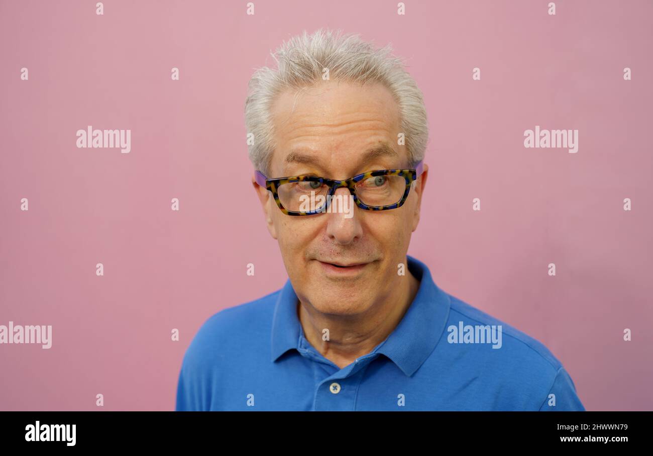 Handsome businessman in blue shirt on pink background Stock Photo