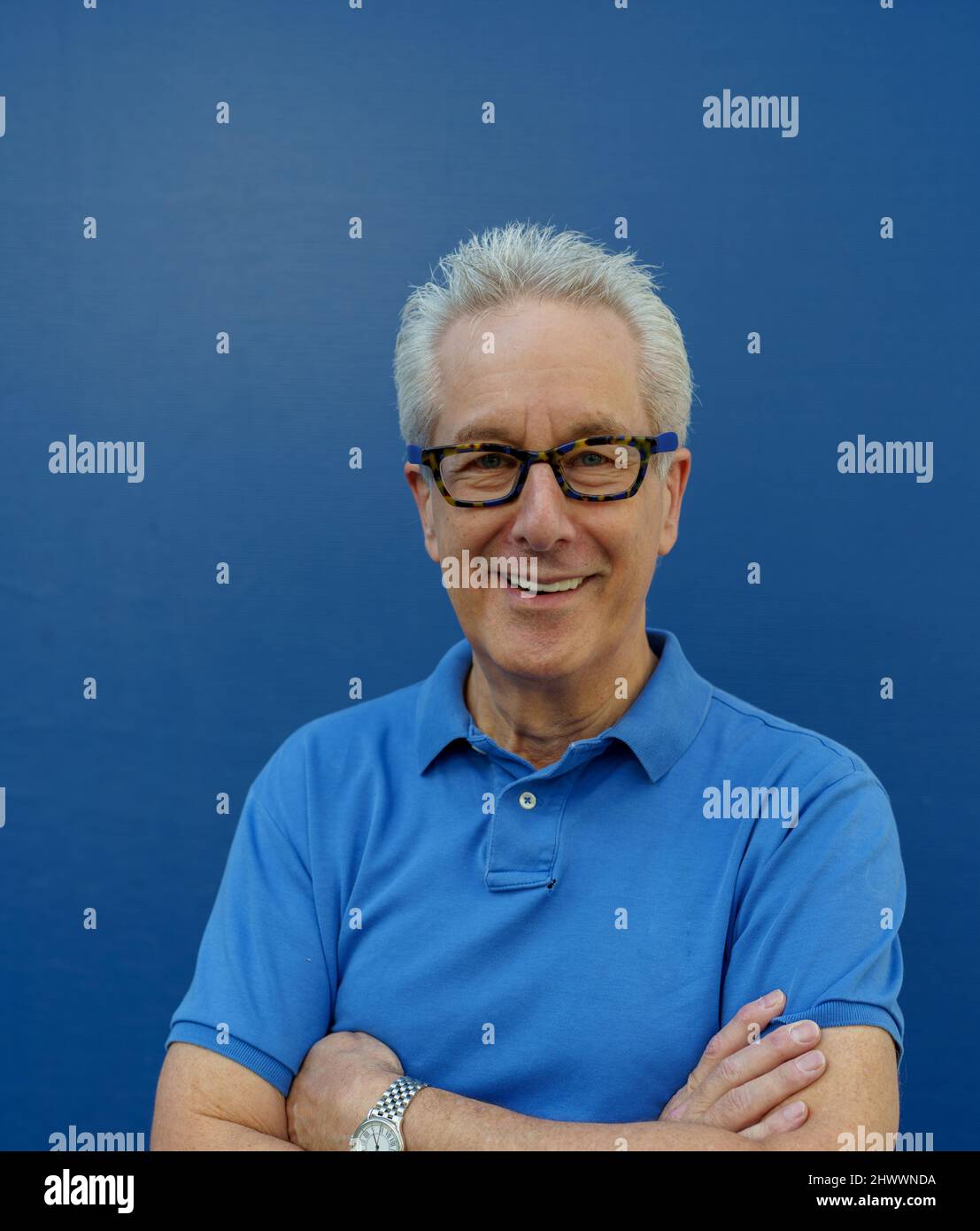 Smiling man with arms crossed Stock Photo