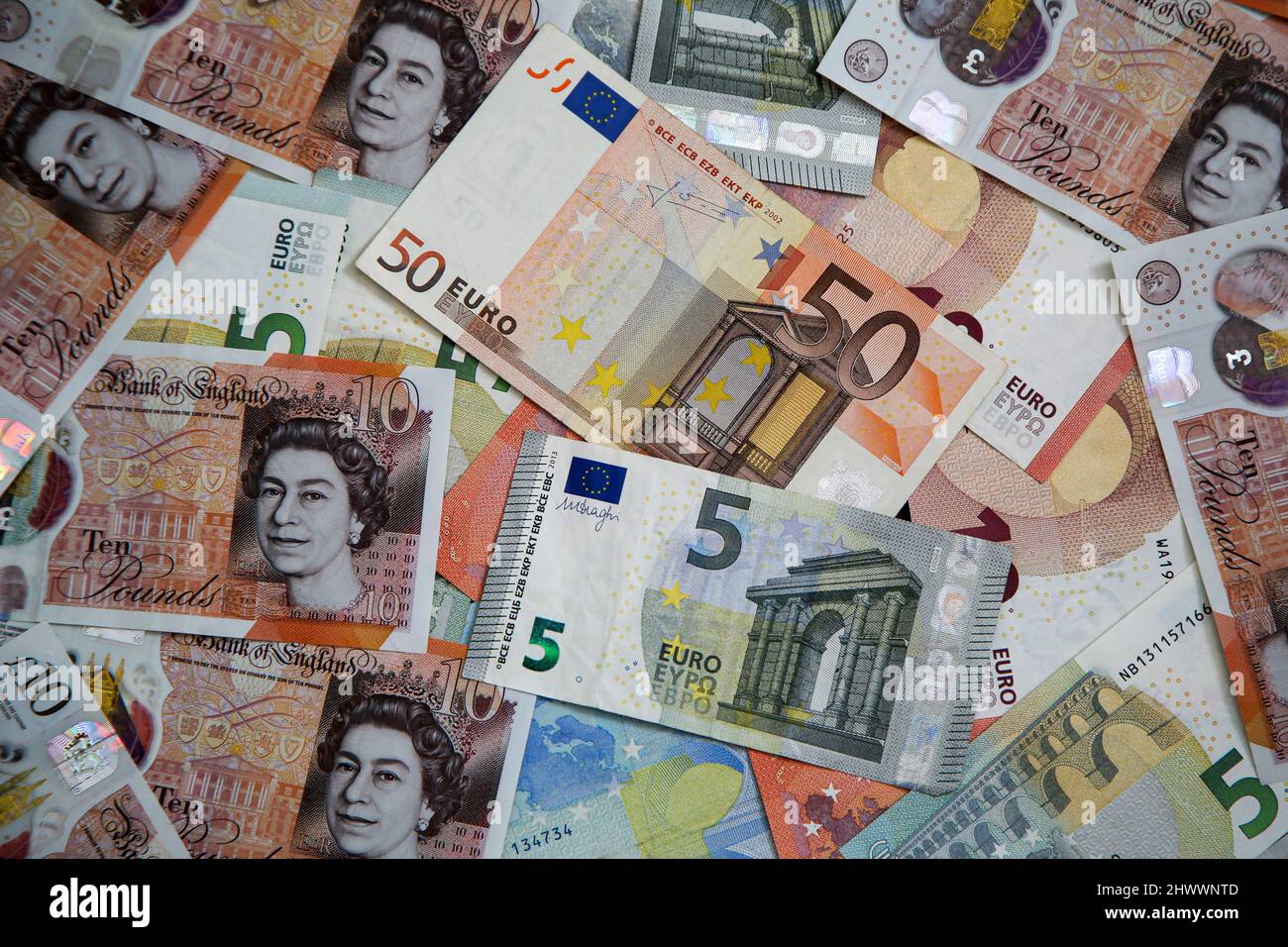 UK. 07th Mar, 2022. In this photo illustration, a collection of British ten  pound sterling and five, ten and fifty Euro banknotes are seen displayed.  British pound hit to its lowest against