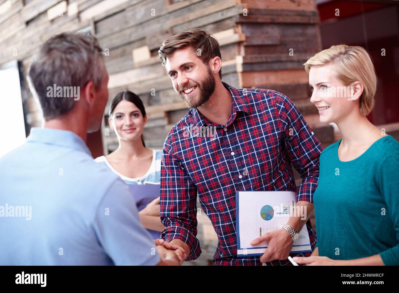 Never stop climbing the corporate ladder. Shot of coworkers shaking hands in an office. Stock Photo