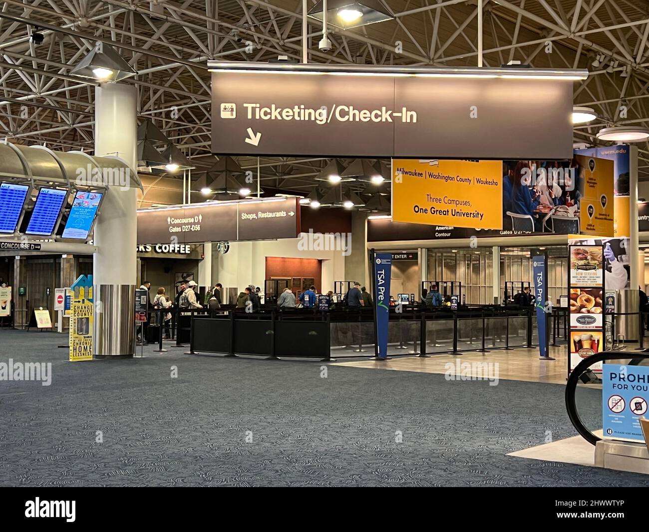 Passengers at TSA security screening line inside main terminal General Mitchell International Airport in Milwaukee, Wisconsin on a Sunday. Stock Photo