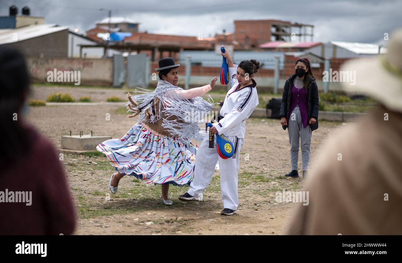 18 February 2022, Bolivia, El Alto: Laura Ramos (r) demonstrates a taekwondo exercise with her assistant, Lidia Maytia (l), during a workshop of the 'Warmi Power' (Women Power) project for self-defense for women. Ramos, a psychologist and taekwondo athlete, created this project with the aim of giving 'women means to prevent violence or fight back.' 'Violence against women is often normalized as part of the culture,' Ramos says. 'Violence is not solved by violence. But it can save someone's life.' (to dpa ''Warmi Power' in Bolivia: Indigenous women fight violence') Photo: Radoslaw Czajkowski/ Stock Photo
