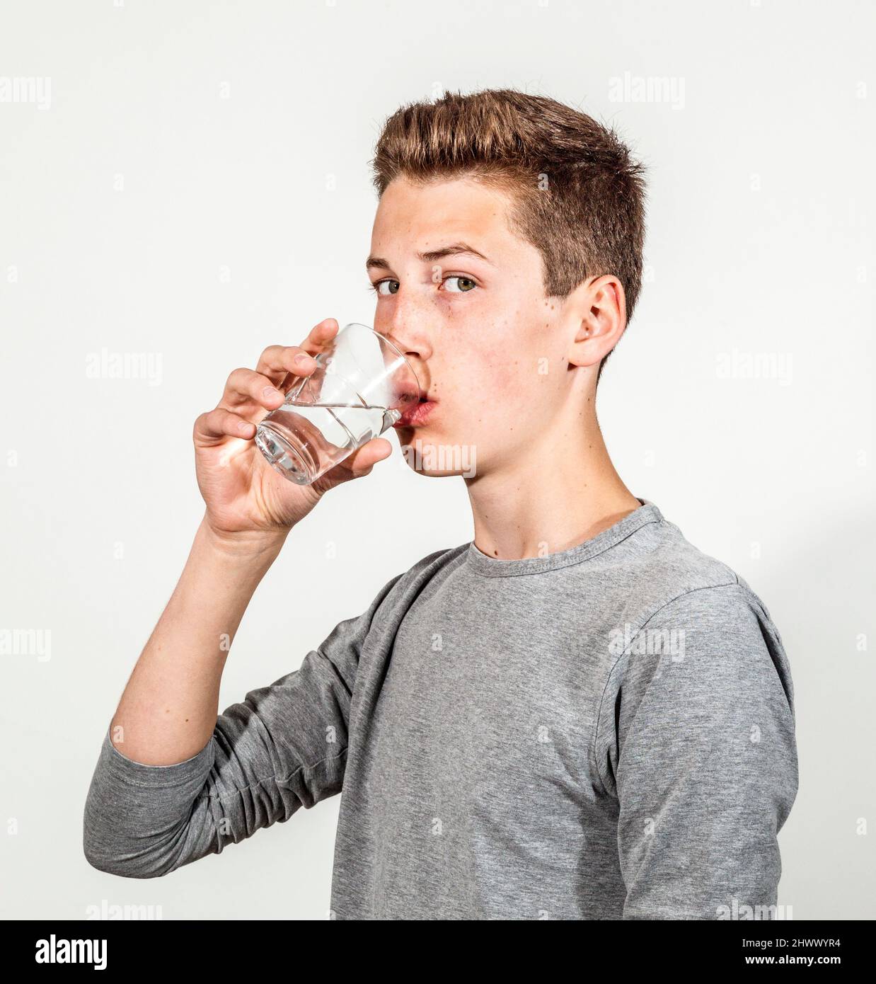 https://c8.alamy.com/comp/2HWWYR4/portrait-of-attractive-caucasian-teenage-boy-drinking-water-2HWWYR4.jpg