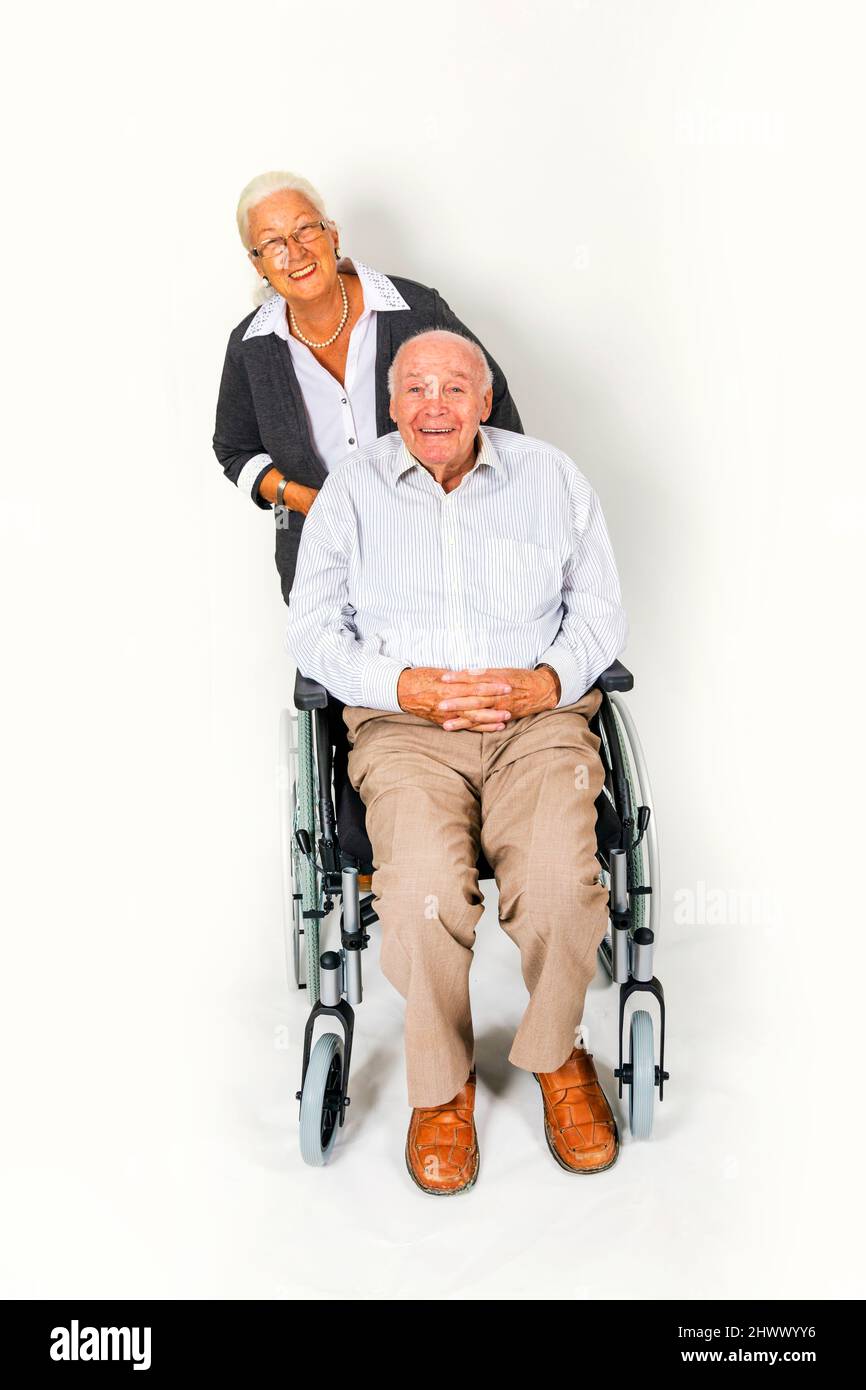 happy senior couple with man in wheelchair Stock Photo