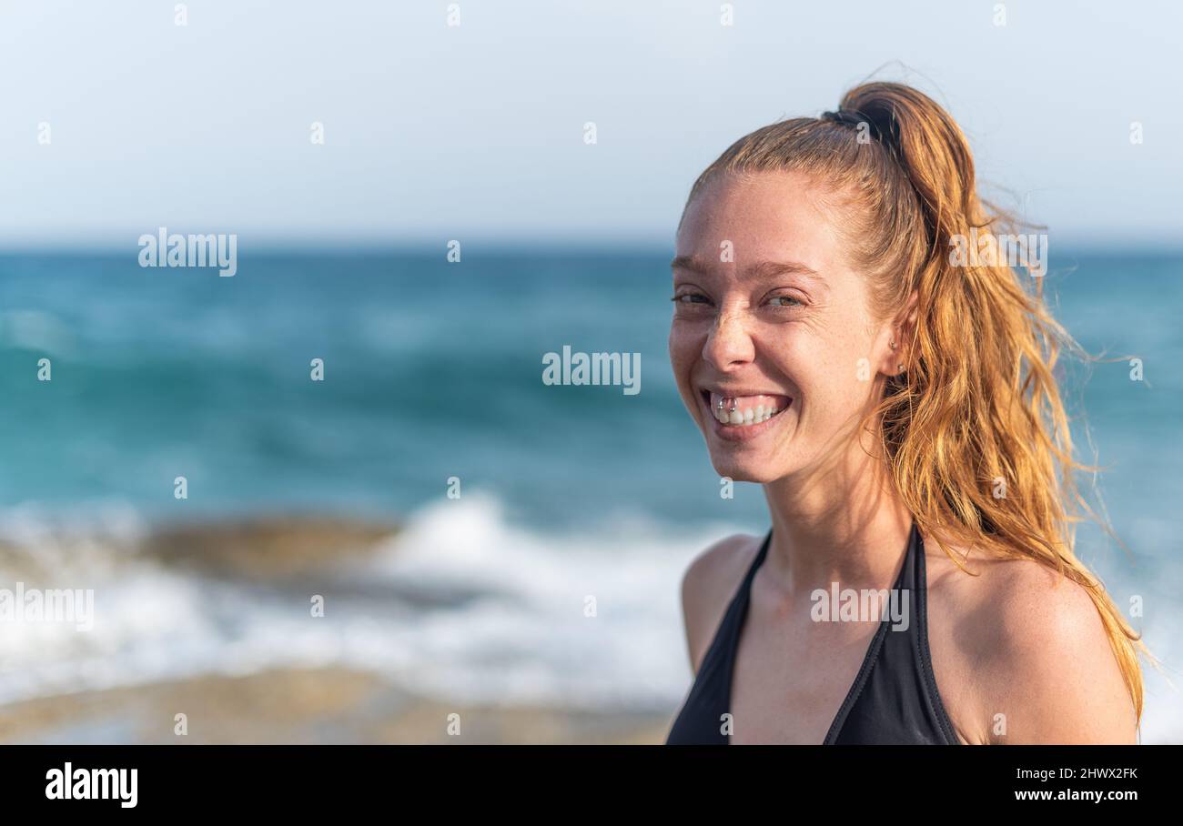 young woman looking at the camera smiling Stock Photo
