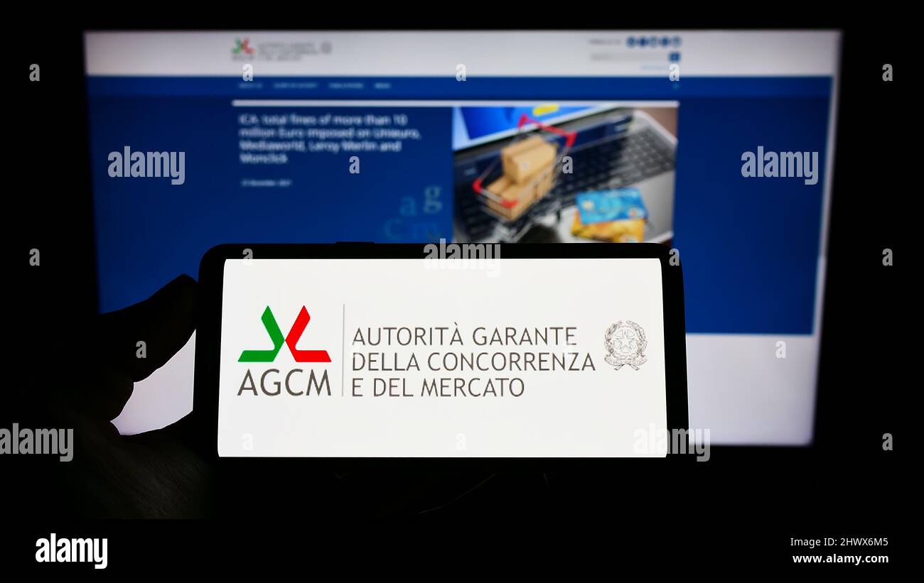 person-holding-cellphone-with-logo-of-italian-competition-authority