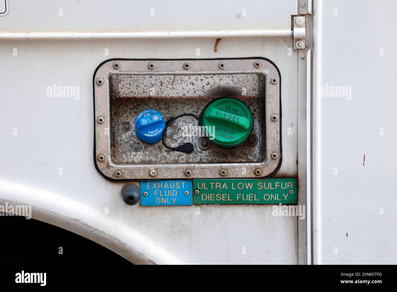 An ultra low sulfur diesel fuel cap and diesel exhaust fluid cap with signs to use ultra low sulfur diesel fuel only. en 590 fuel. biodiesel. Stock Photo