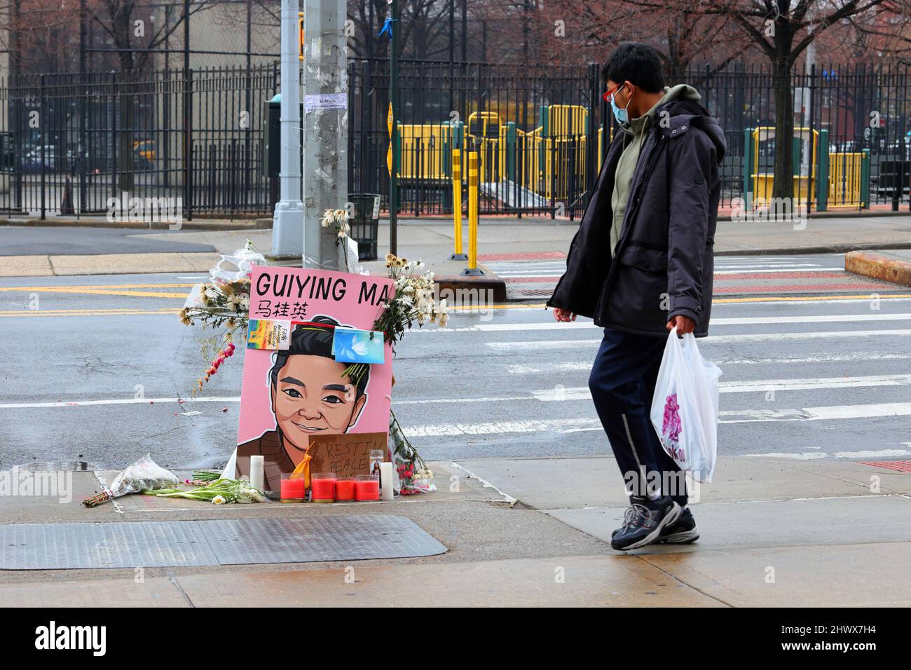 6th March 2022, New York, NY. A person walks by a street memorial to GuiYing Ma located outside Elmhurst Hospital. The elderly woman was attacked ... Stock Photo