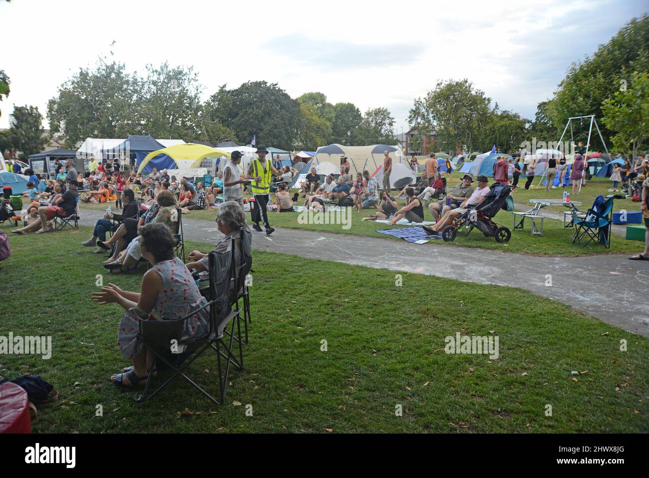 Christchurch, New Zealand, February 22, 2021: A crowd gathers for a music performance at the Cranmer Square mandate protest in Christchurch. Activists pitched tents and occupied the square peacefully for several weeks. Stock Photo