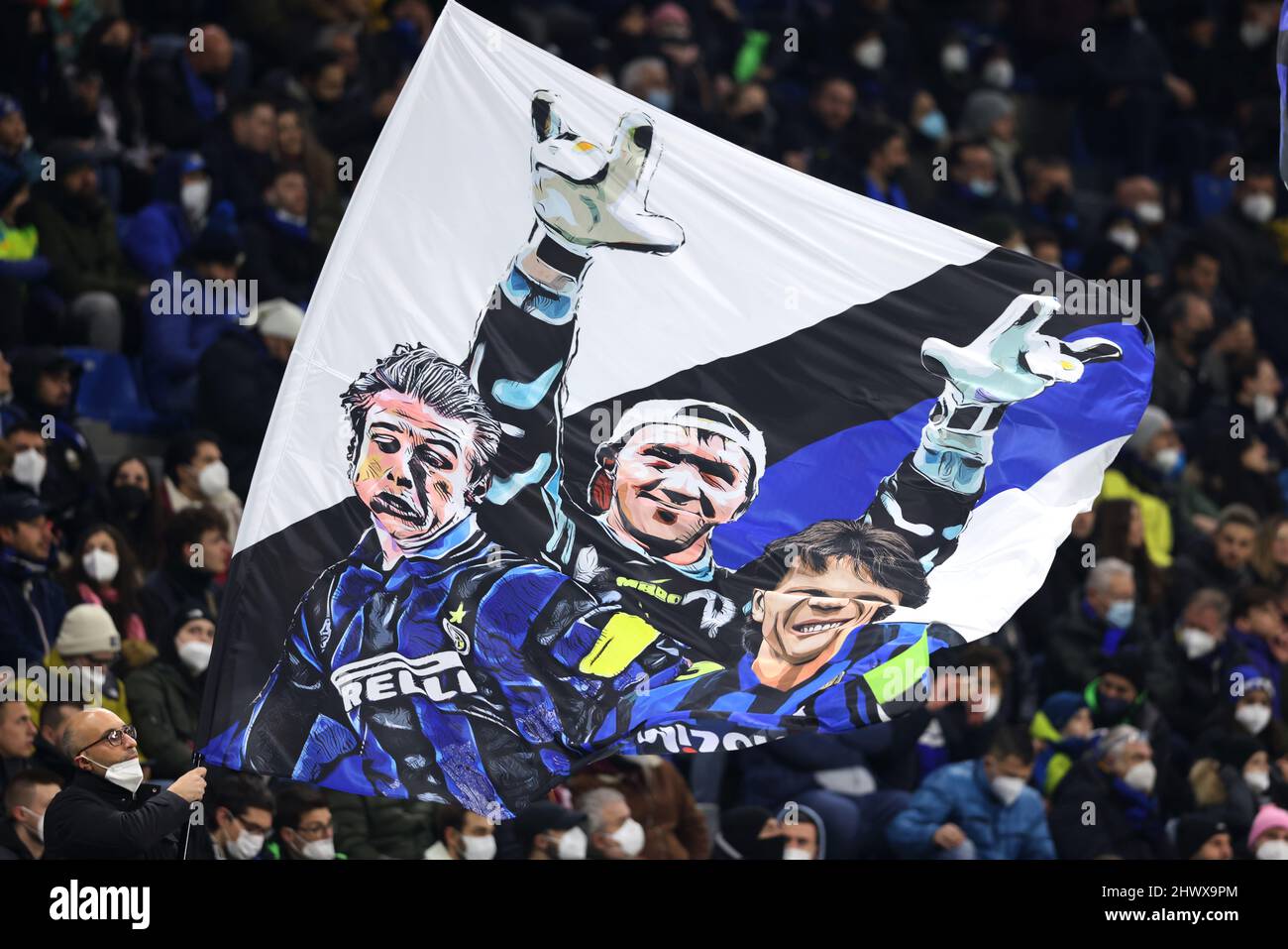 Milan, Italy, 4th March 2022. An FC Internazionale fan waves a flag bearing images of former players Andreas Brehme, Walter Zenga and Lothar Matthaus during the Serie A match at Giuseppe Meazza, Milan. Picture credit should read: Jonathan Moscrop / Sportimage Stock Photo