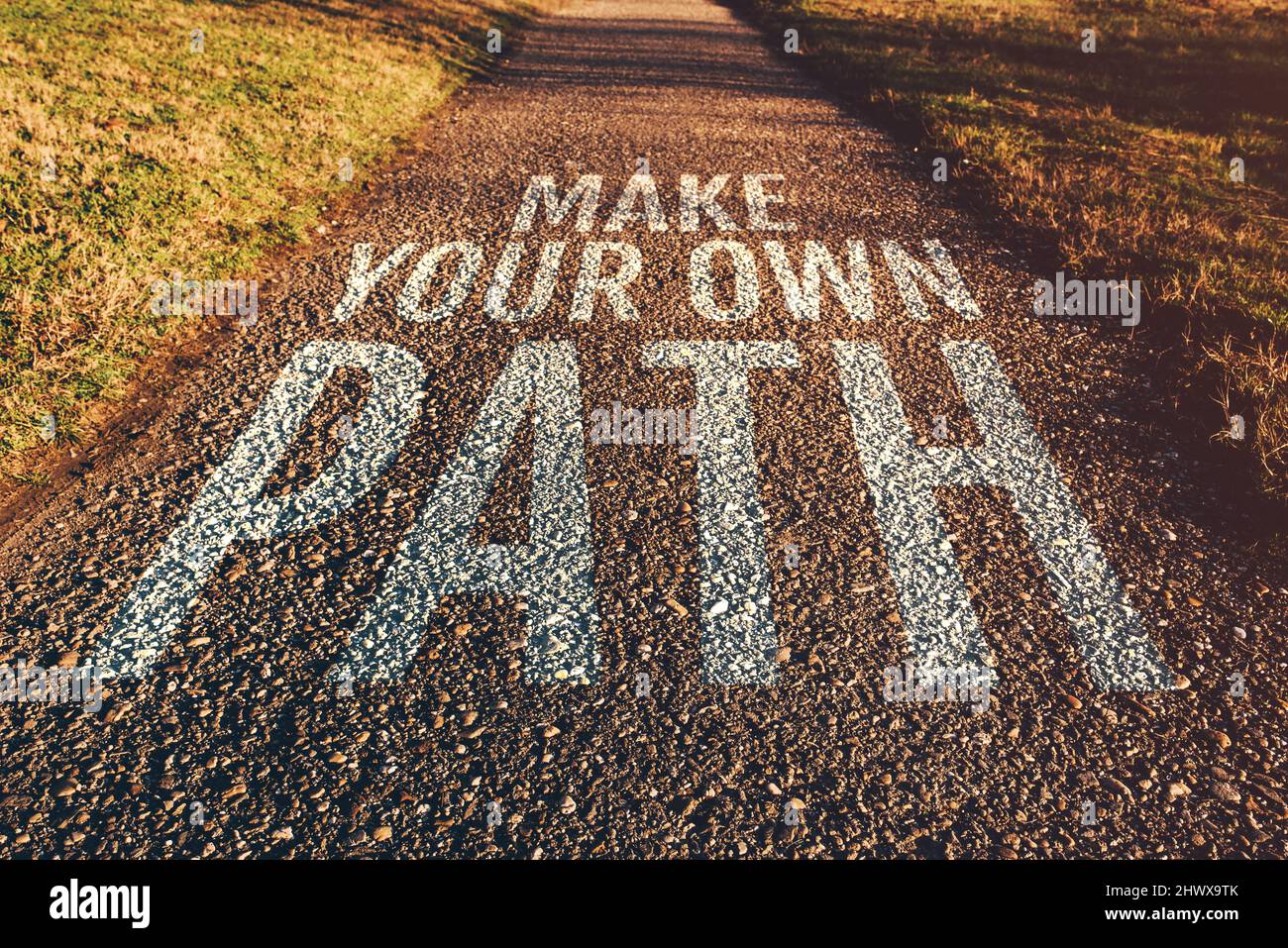 Make your own path motivational quote on footpath leading through park in  diminishing perspective, selective focus Stock Photo - Alamy