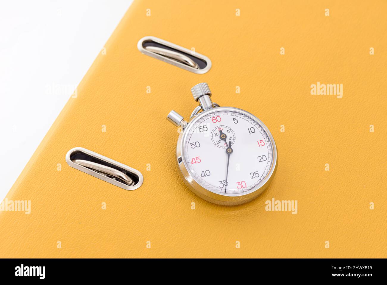 Yellow office folder on the chronometer. Stock Photo