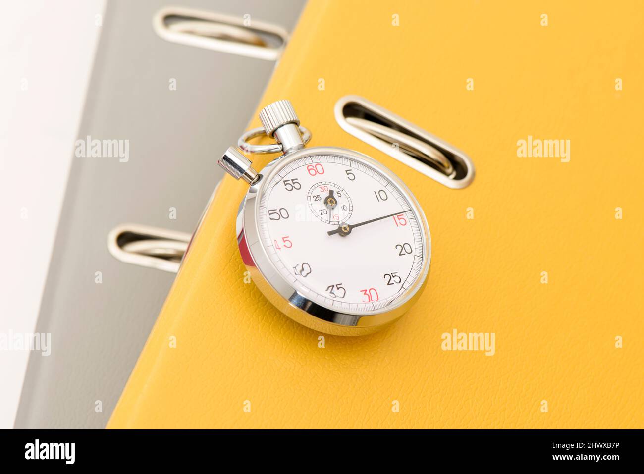 Yellow office folder on the chronometer. Stock Photo