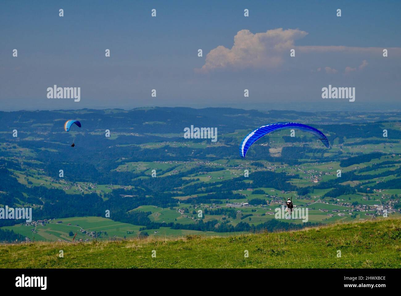 Paragliders taking off at Niedere in Bregenzerwald. Vorarlberg, Austria. High quality photo Stock Photo