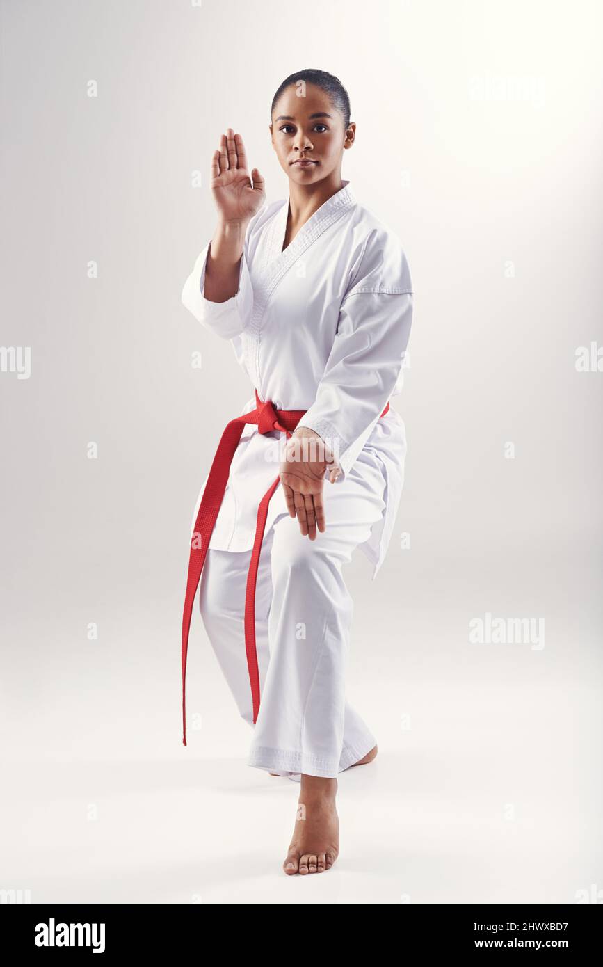 Discipline is at the heart of martial arts. An ethnic woman doing karate. Stock Photo