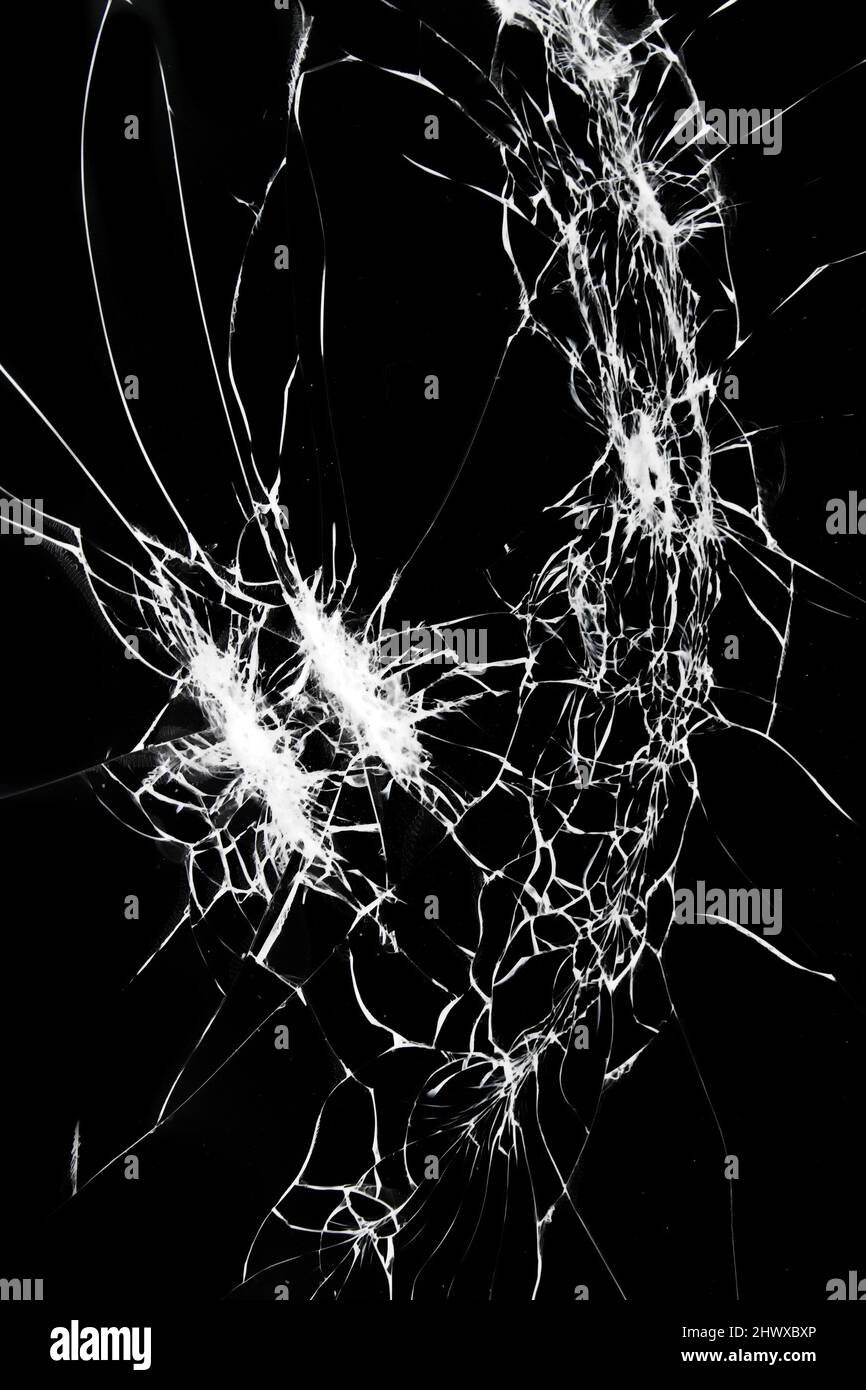 Broken glass on smartphone screen. Cracks on a black background. Stock Photo