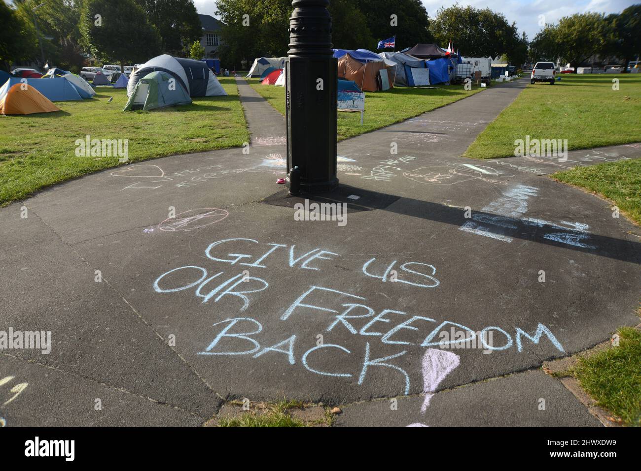 Christchurch, New Zealand, February 22, 2021: Sidewalk graffiti at the Cranmer Square mandate protest in Christchurch. Activists pitched tents and occupied the square peacefully for several weeks. Stock Photo