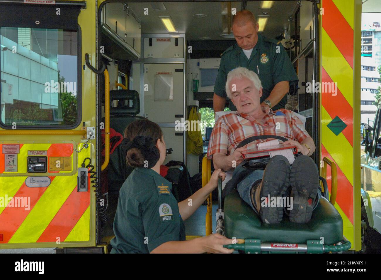 Paramedics load an elderly patient onto an ambulance.(MODEL RELEASED
