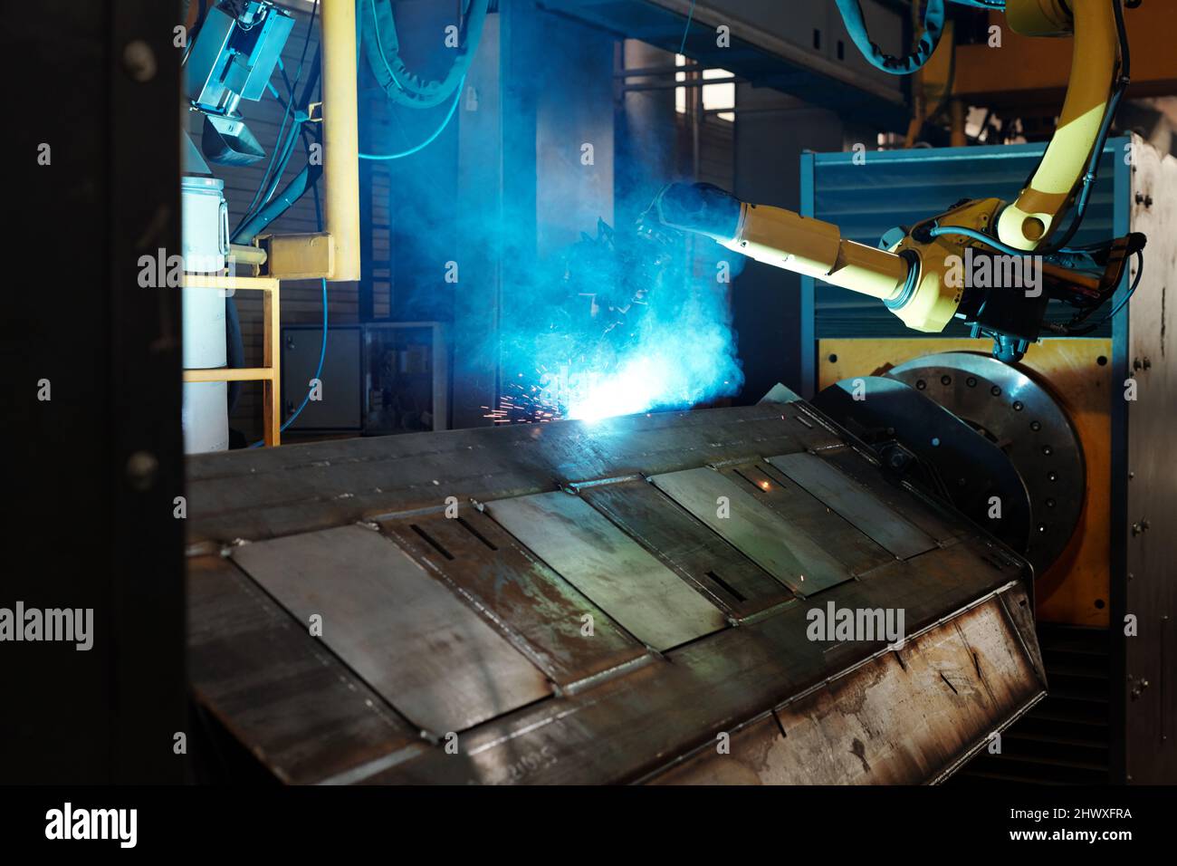 Process of arc welding produced by huge robotic industrial machine in