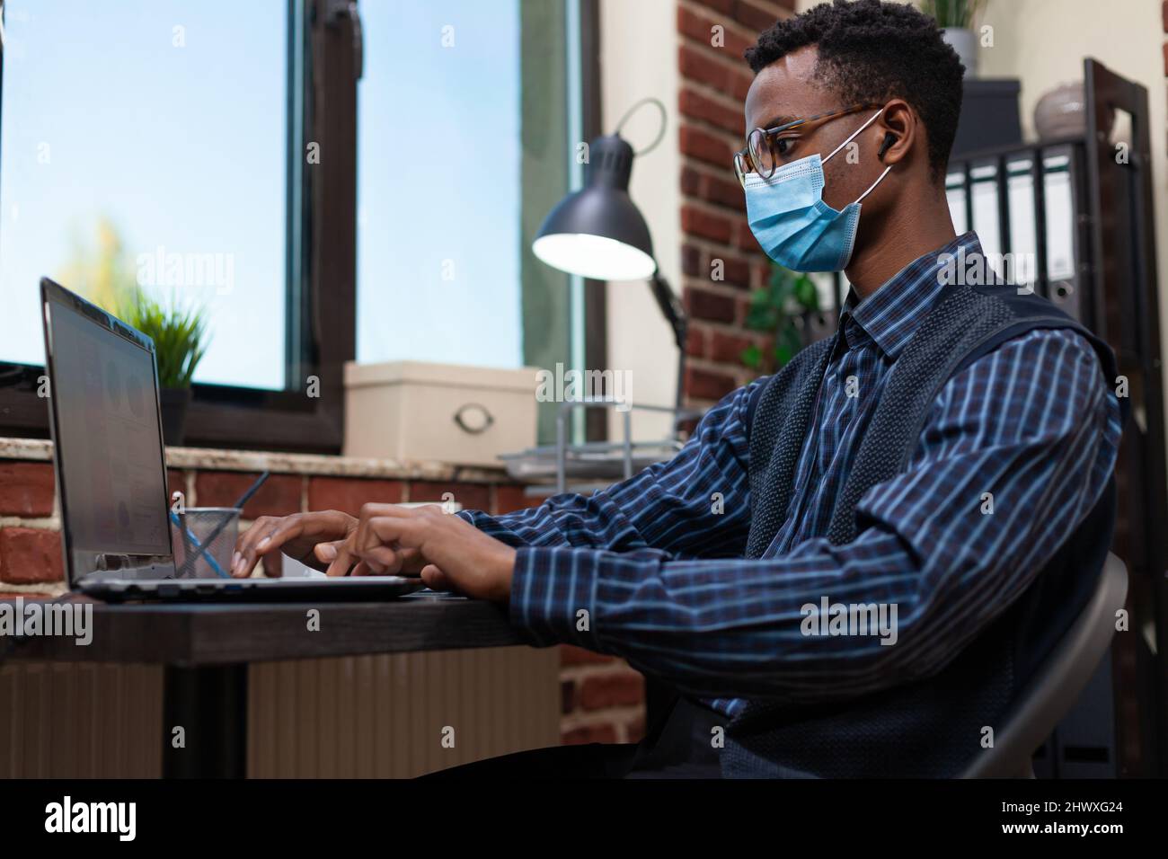 Portrait of marketing specialist wearing covid protective face mask ...