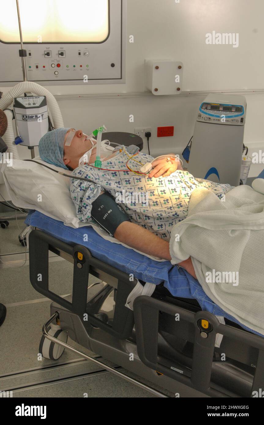 A patient under anaesthetic lies in a surgey prior to undergoing an operation.(MODEL RELEASED) Stock Photo