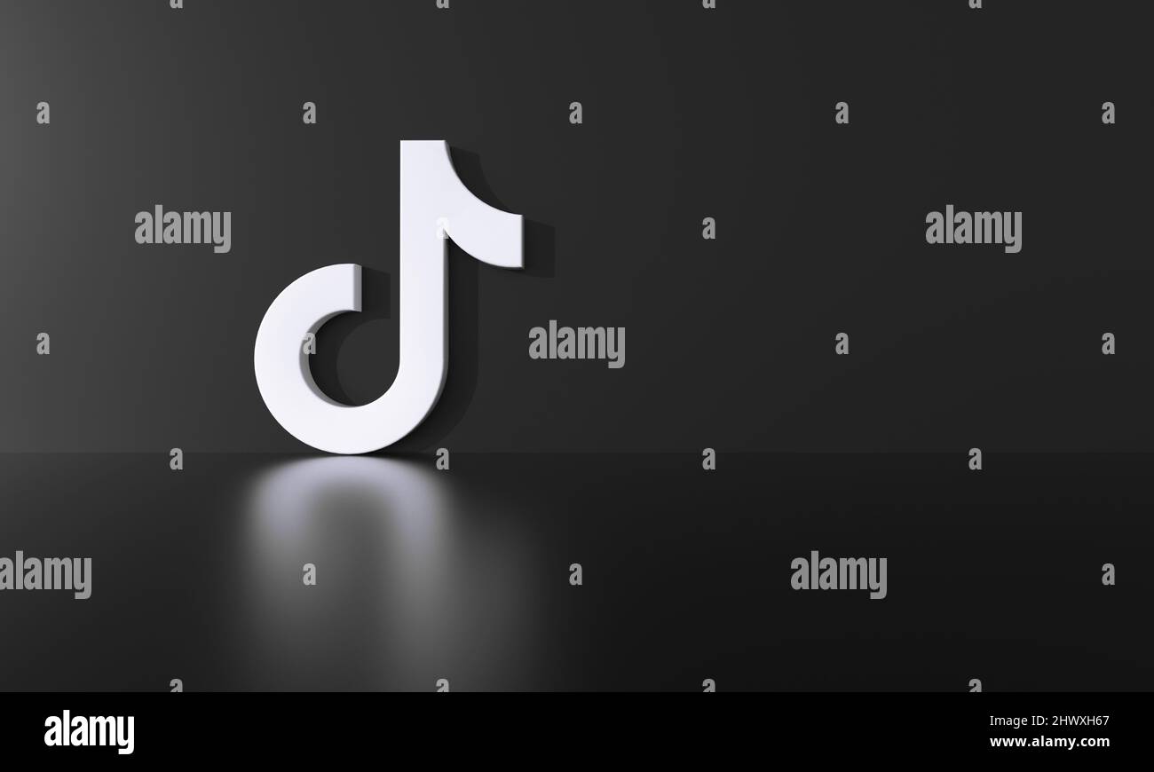 Tik Tok logo on black wall background with hard shadow and space for