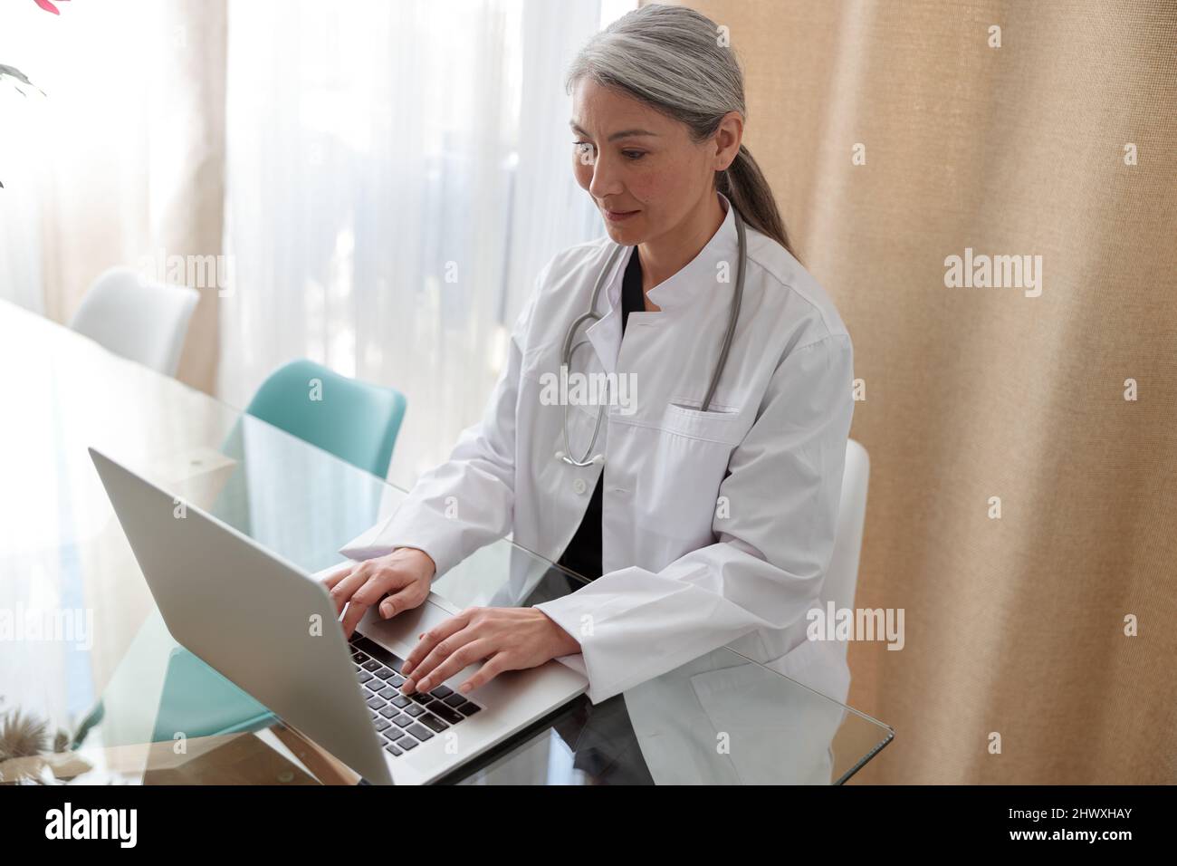 Medical specialist working on laptop at office Stock Photo Alamy