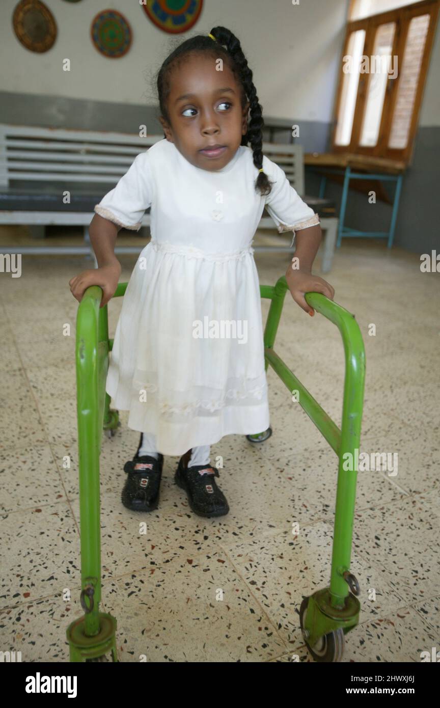 Young girl using a walking aid due to her suffering from osteogenesis imperfecta. Stock Photo