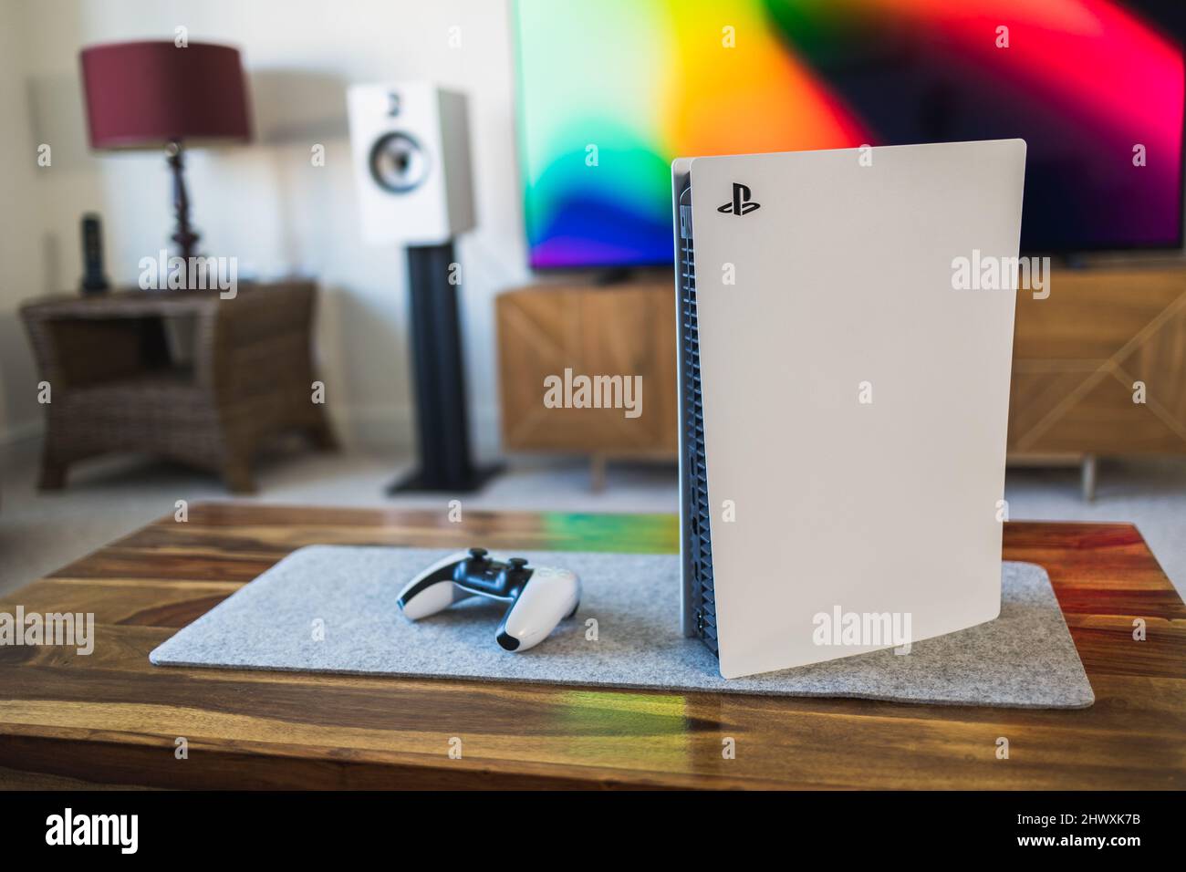 PlayStation 5 video games console and PS5 controller by living room tv Stock Photo