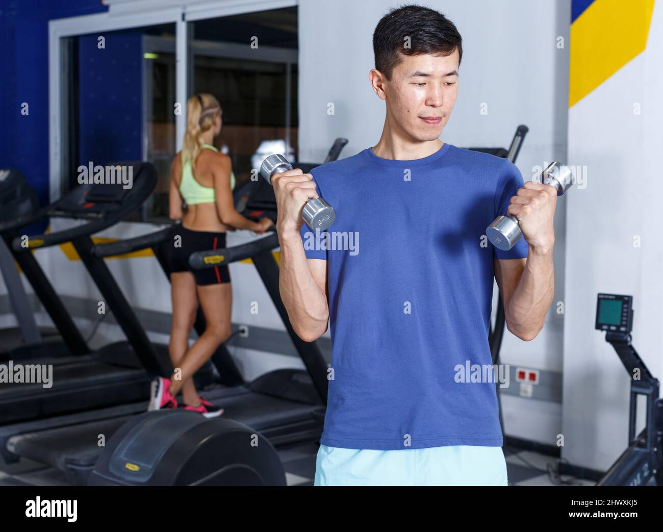 Man doing exercises with dumbbells Stock Photo