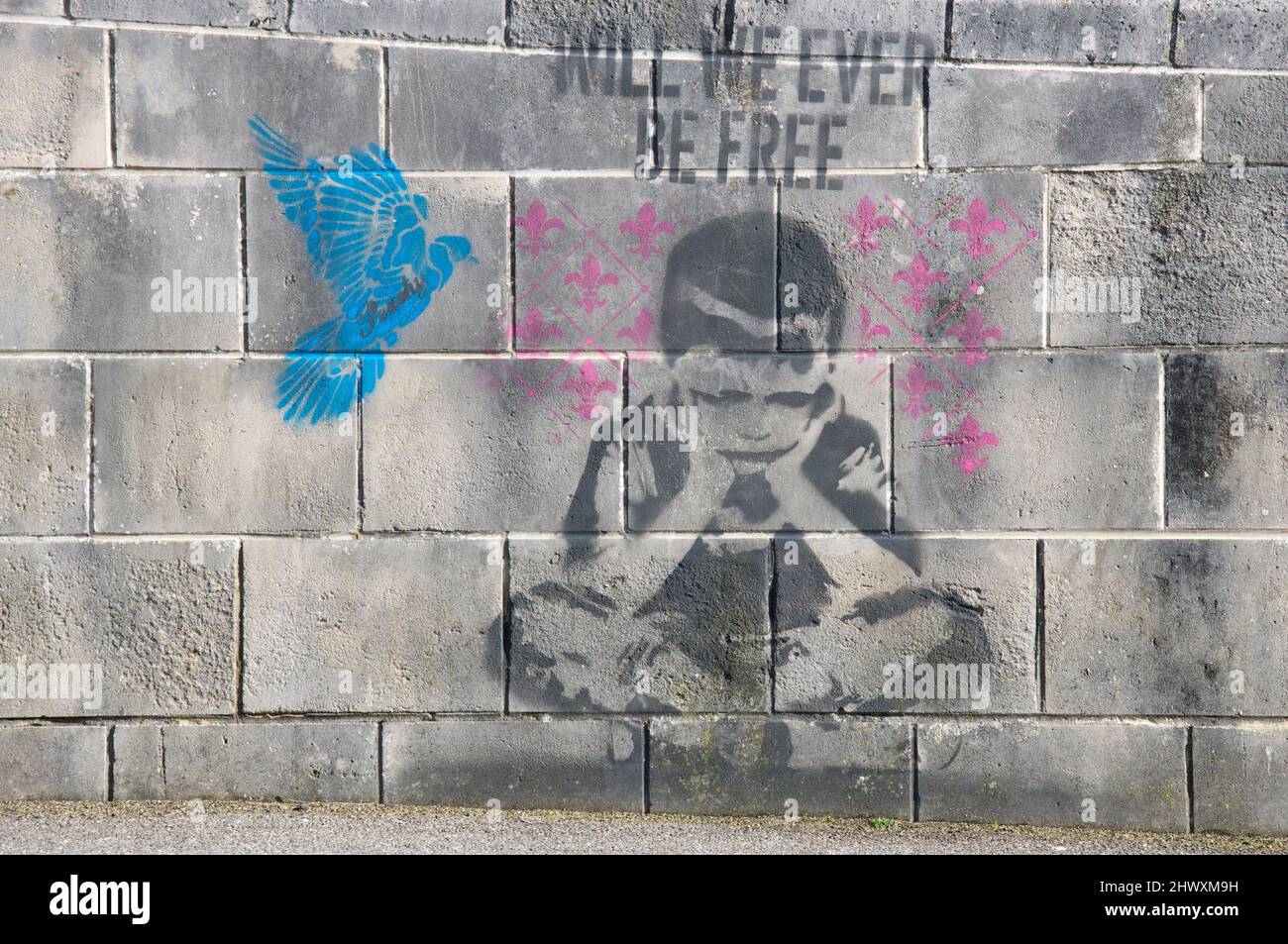 Will we ever be free: Graffiti street art made with aerosol and stencils painted on a sea wall in Weymouth. By the artist known as Peachy. Dorset, UK. Stock Photo