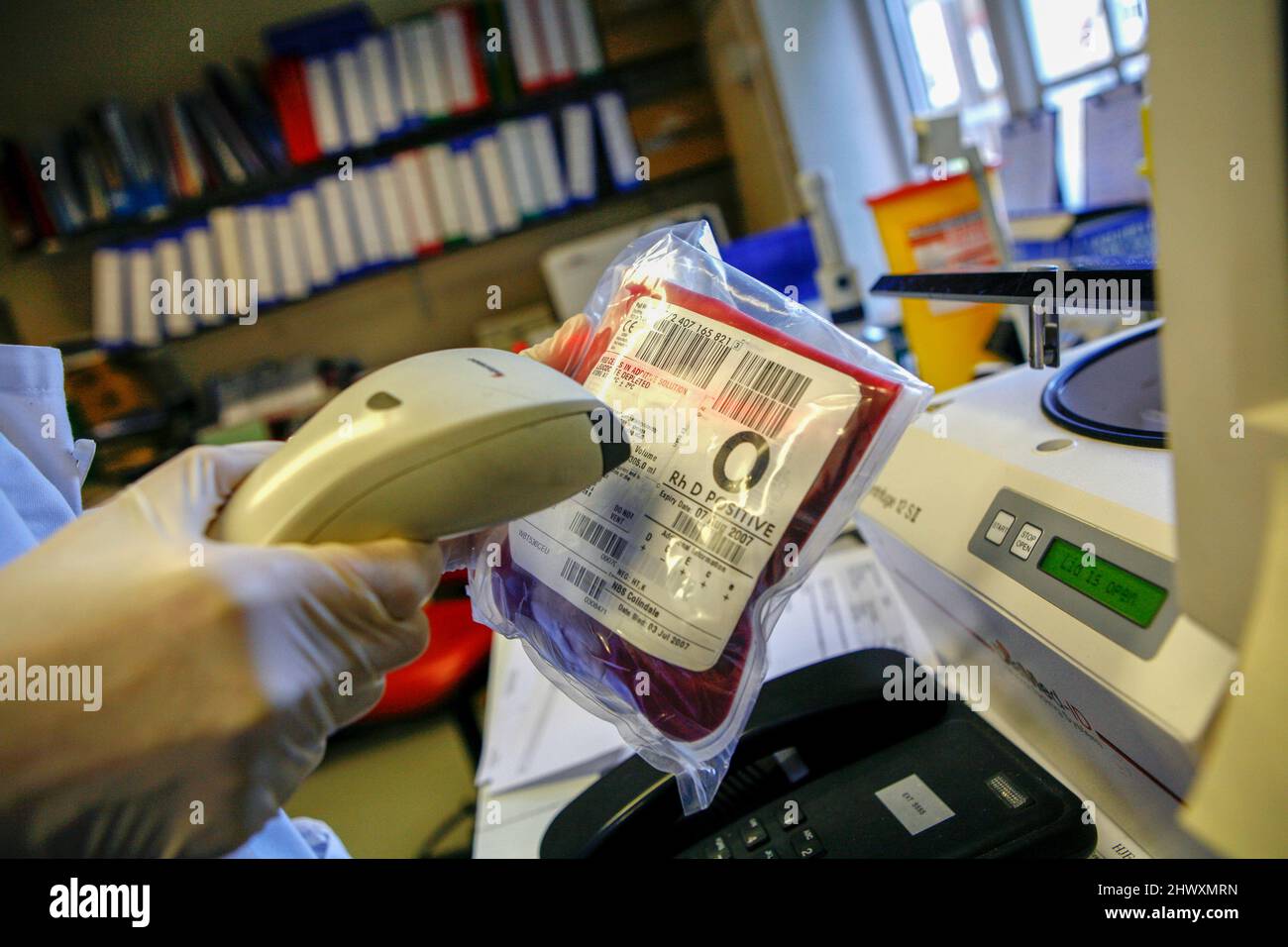 A technician scans the bar code on bags of donated blood. The bar codes
