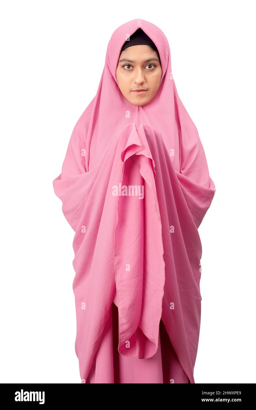 Asian Muslim woman in a veil standing while raised hands and praying ...