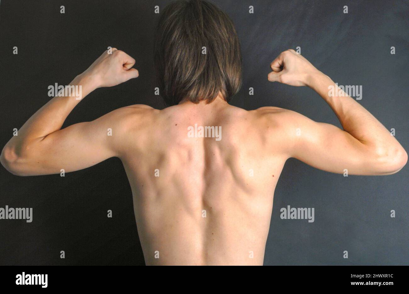 Teenage Boy Flexing Muscles Stock Photo - Download Image Now - Muscular  Build, Swimming Pool, Teenage Boys - iStock