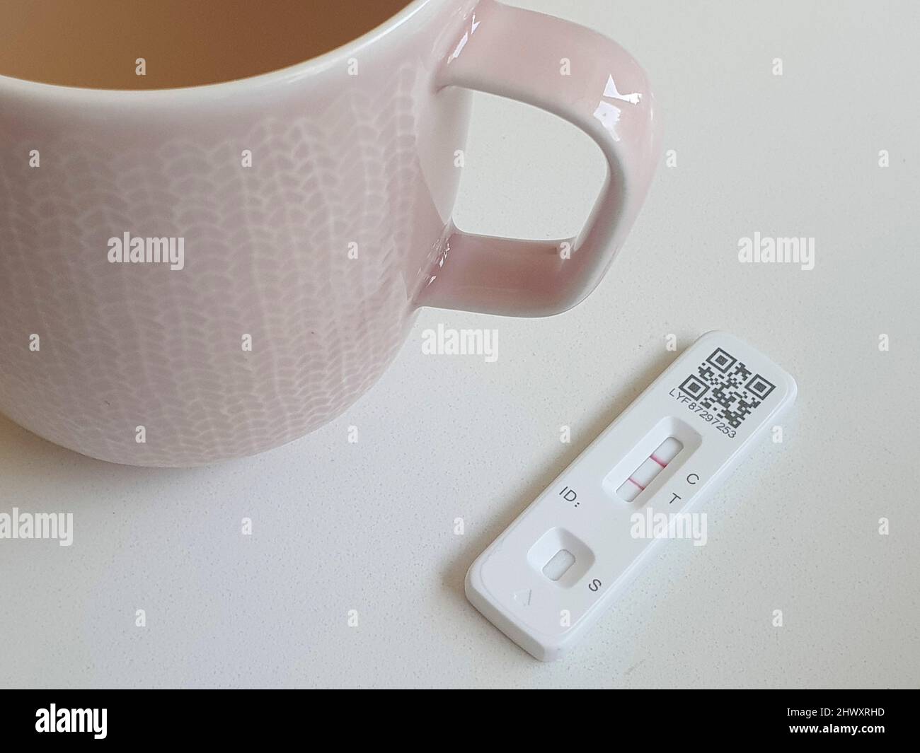 London, UK, 7 March 2022: A mug of Lemsip and a positive covid test. Since the government ended almost all coronavirus restrictions people who test positive with a rapid antigen test no longer need to get confirmation from a PCR test. While this saves money there is concern that new variants may not be identified. Anna Watson/Alamy Live News Stock Photo