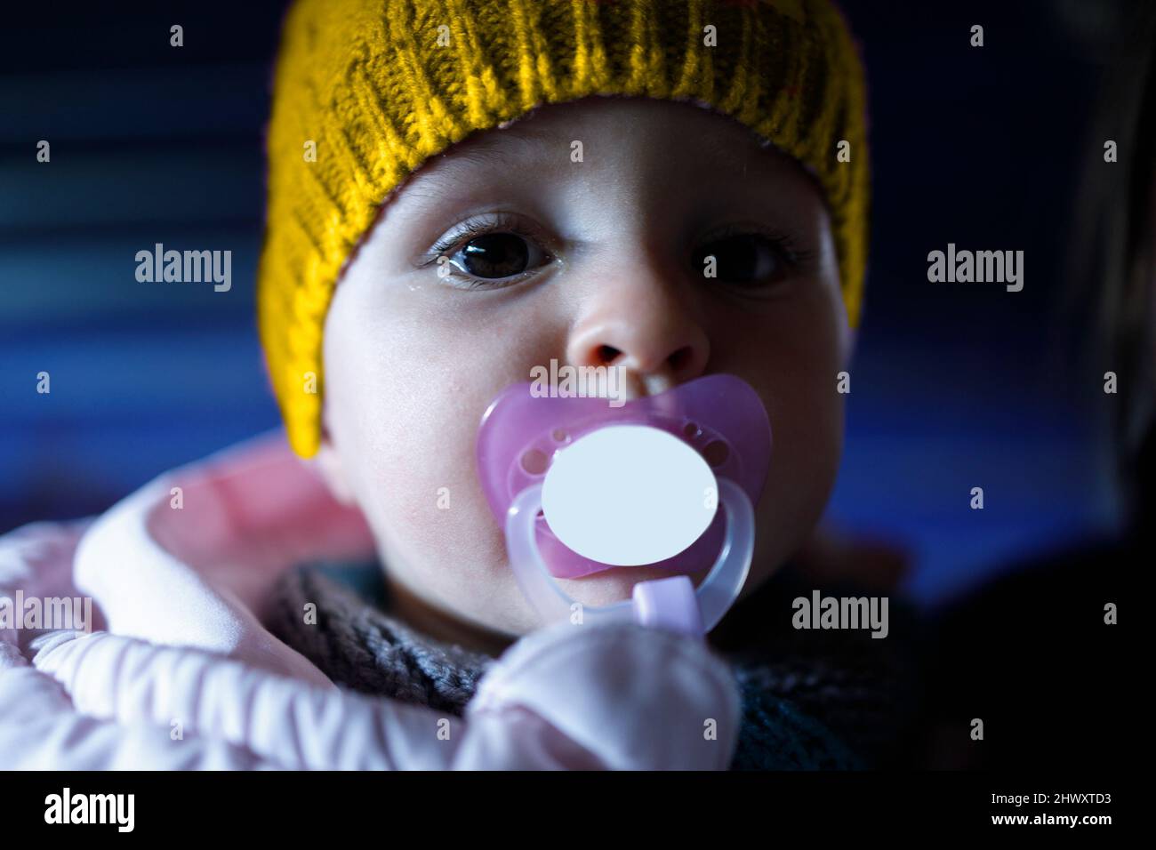 An innocent child looking fearfully into the camera Stock Photo