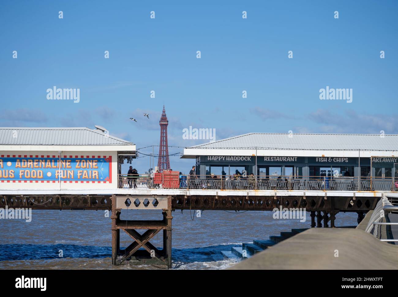 Blackpool Tower, the iconic landmark in the popular seaside resort of Blackpool, Lancashire, with buildings on South Pier in the foreground Stock Photo