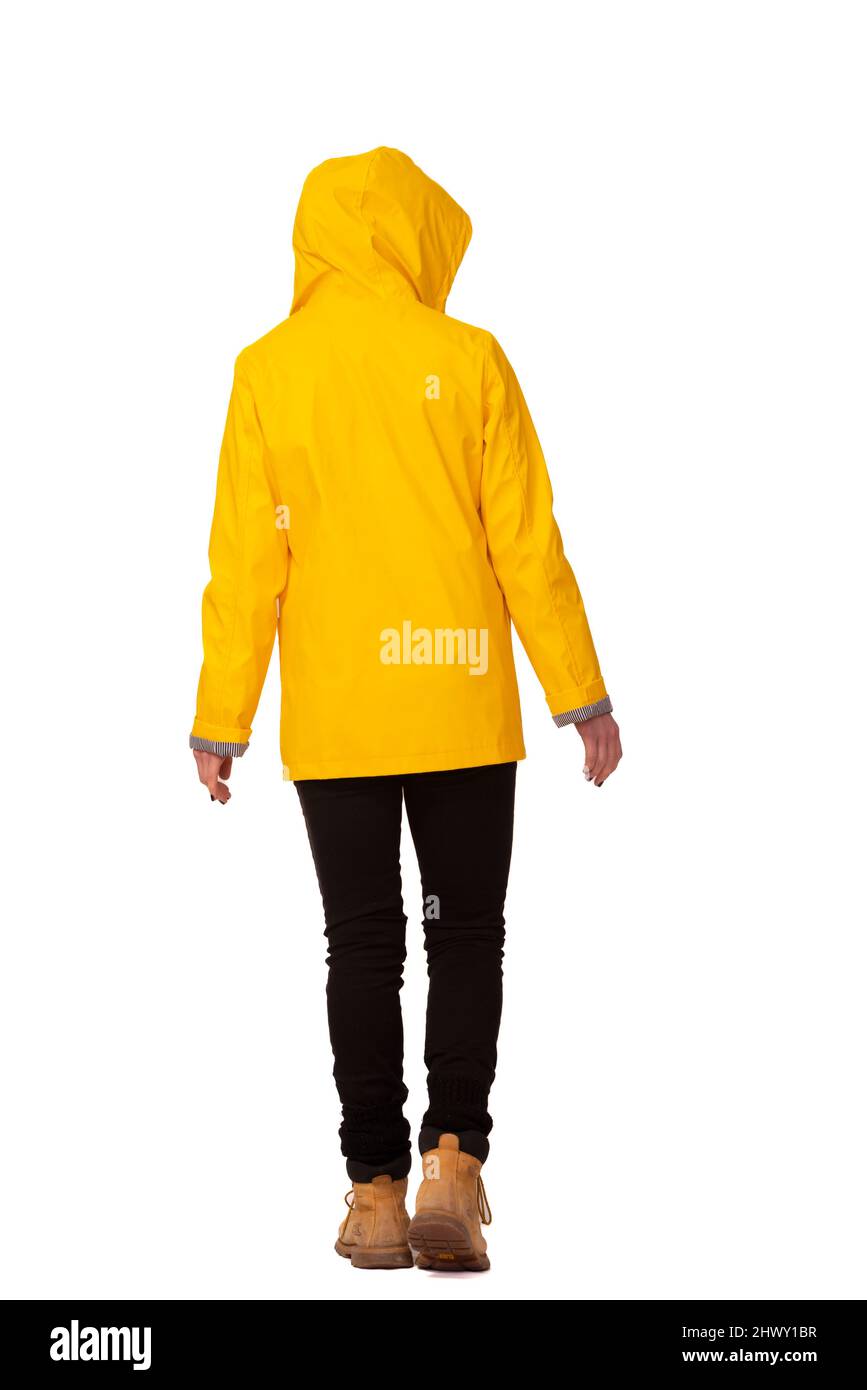 Rear view of a woman wearing a yellow coat with hood up, cut out, Stock Photo