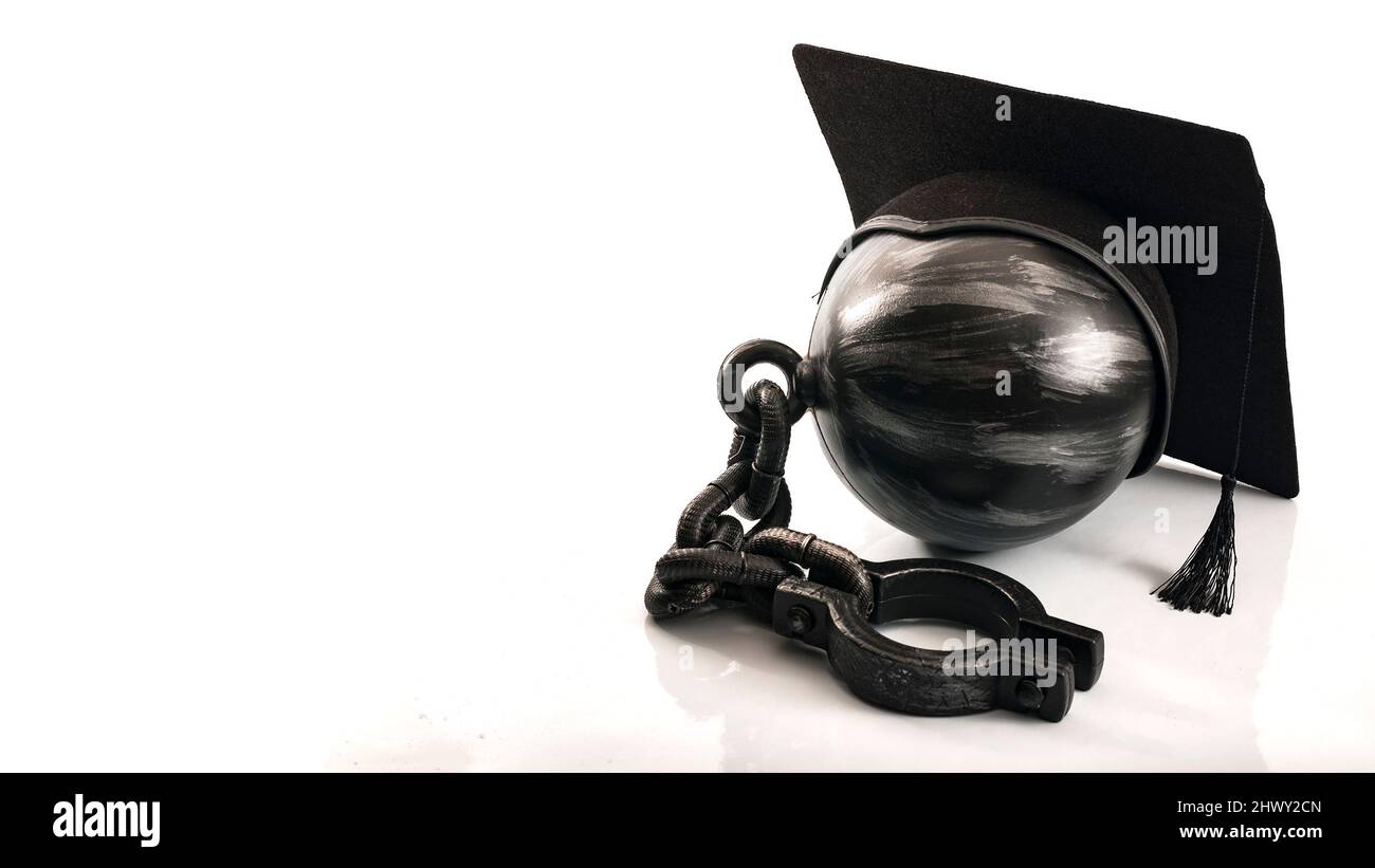 Student debt concept with ball and chain wearing graduation cap