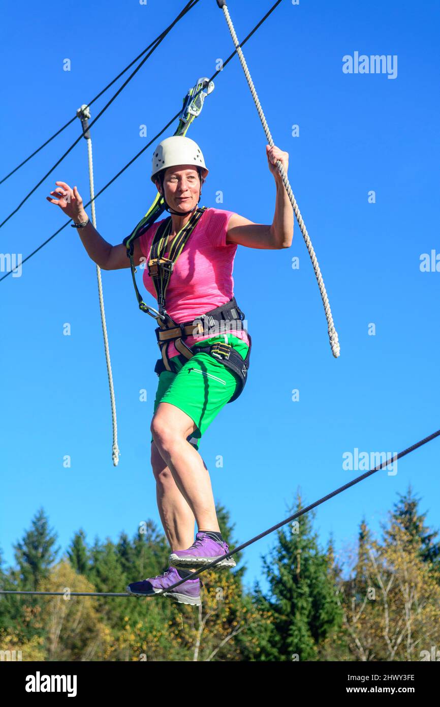 Balancing exercise in high ropes course Stock Photo Alamy