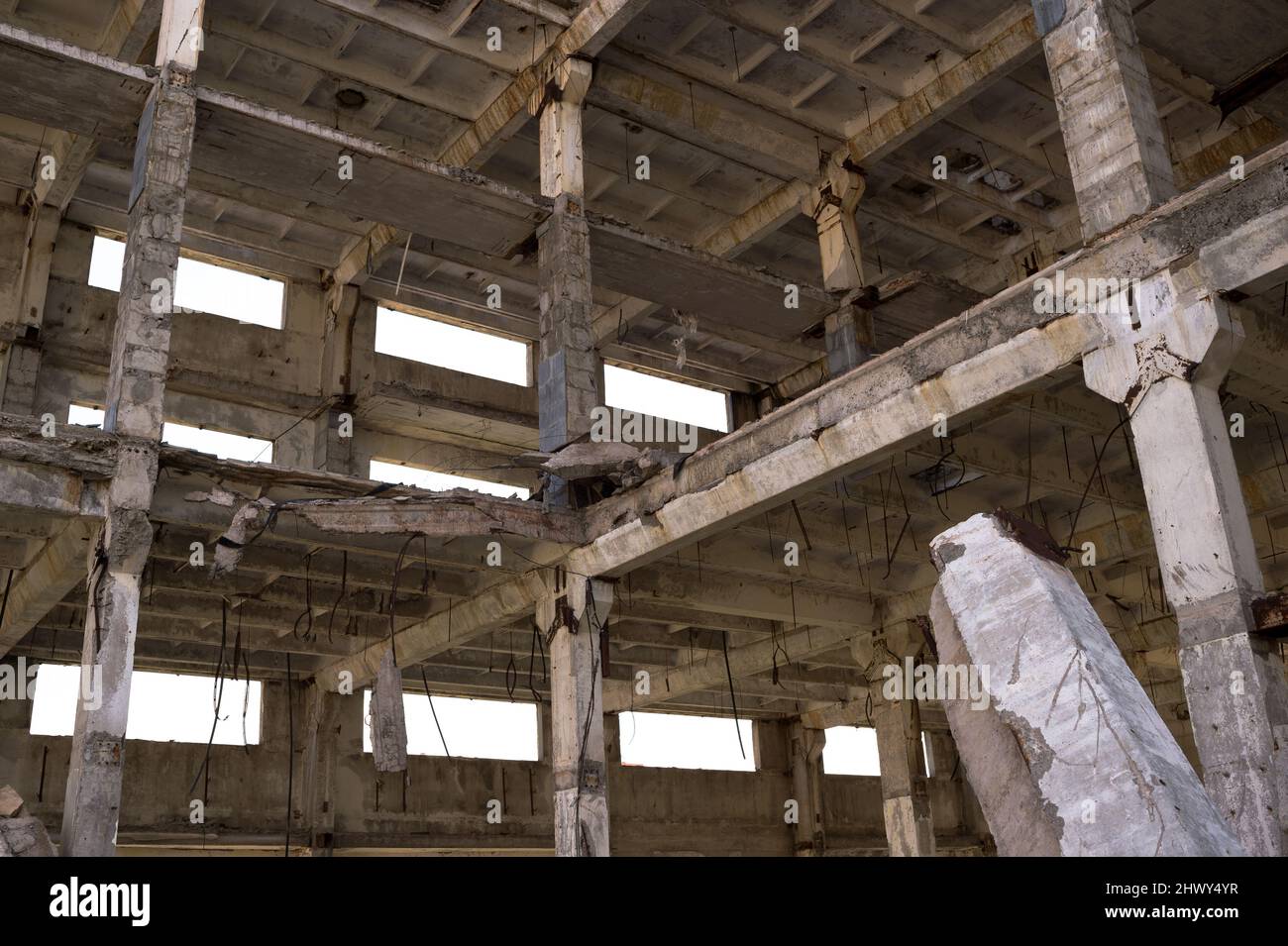 The frame of a large building is a close-up with concrete beams with a ...