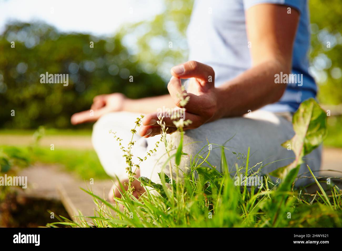 Becoming one with nature. Cropped shot of a man meditating in the outdoors. Stock Photo