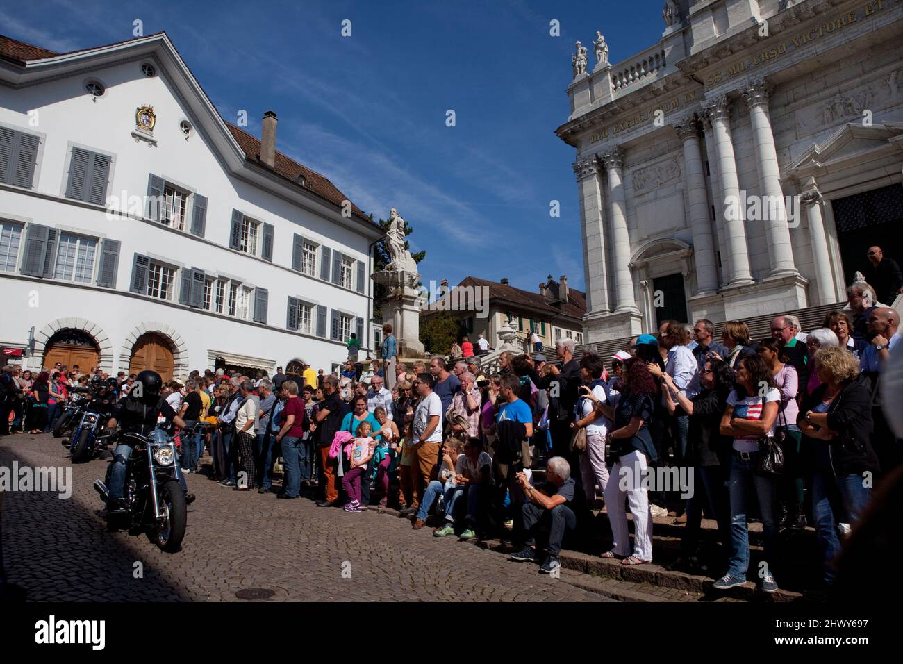 A crowd watches a parade of motorcyclists in Solothurn, Switzerland. Stock Photo