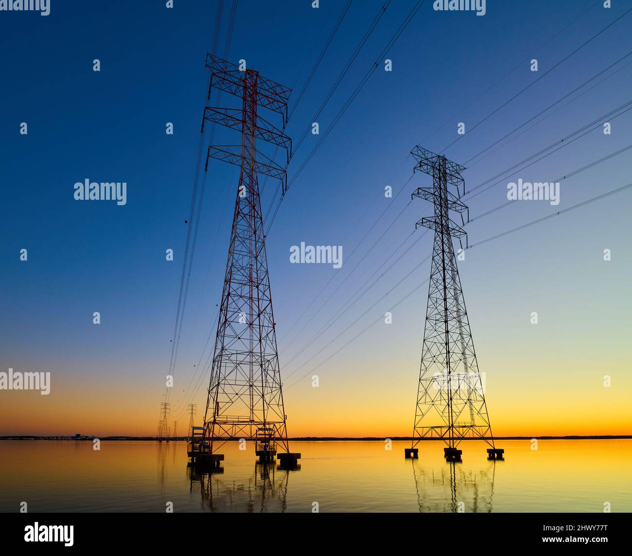 High voltage transmission lines crossing Wheeler Lake at dusk near