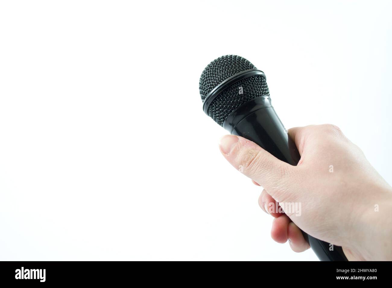 hand holding a microphone on white background Stock Photo